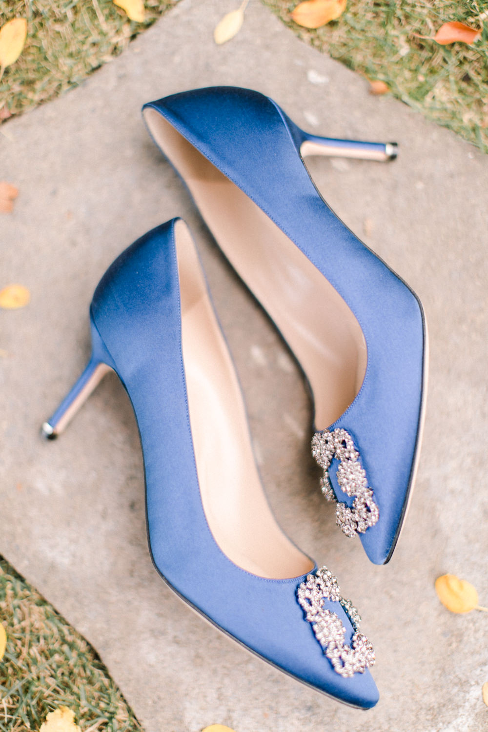 detail shot of a pair of blue Manolo Blahnik wedding shoes at the lake house in Calgary