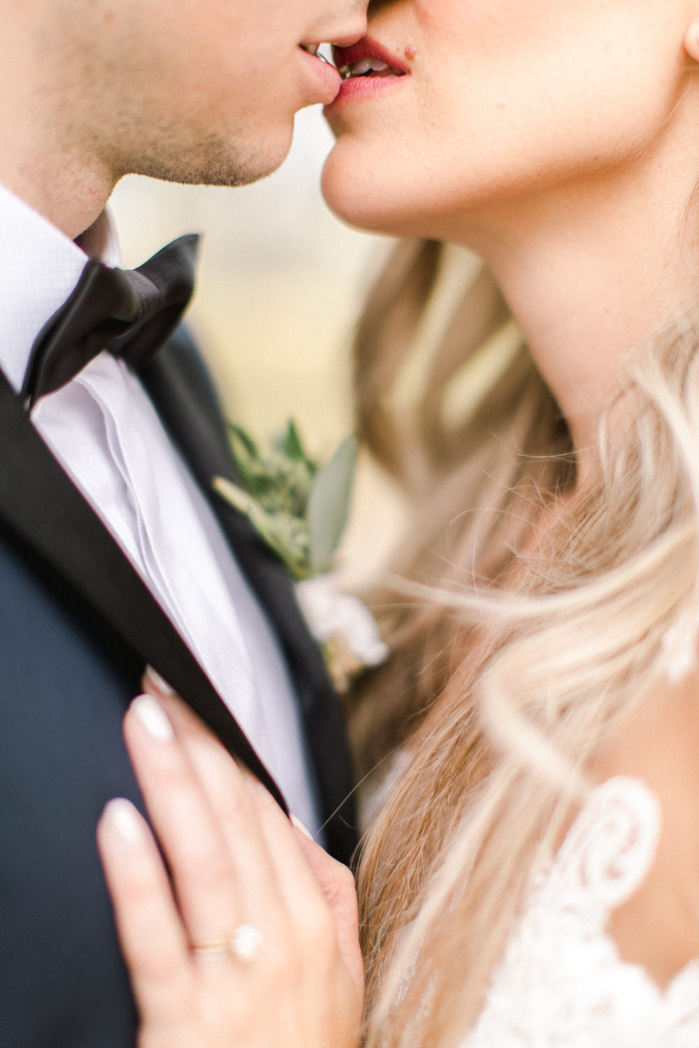 close up shot of the bride and groom kissing at the lake house in Calgary