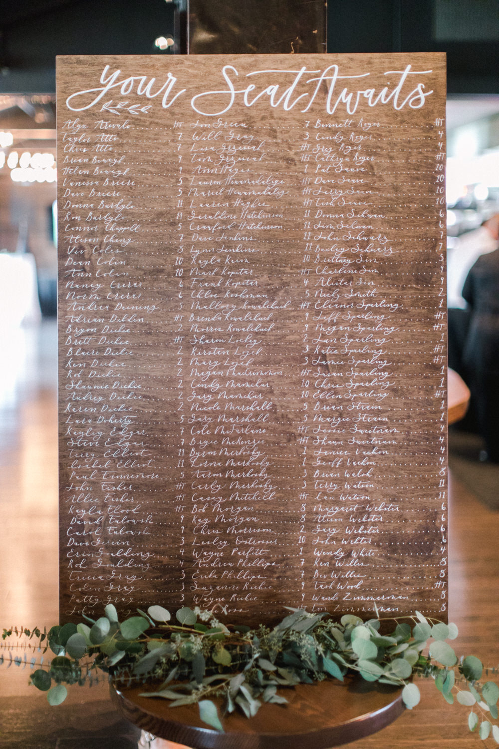 close up shot of a wedding reception seating chart at the lake house in Calgary