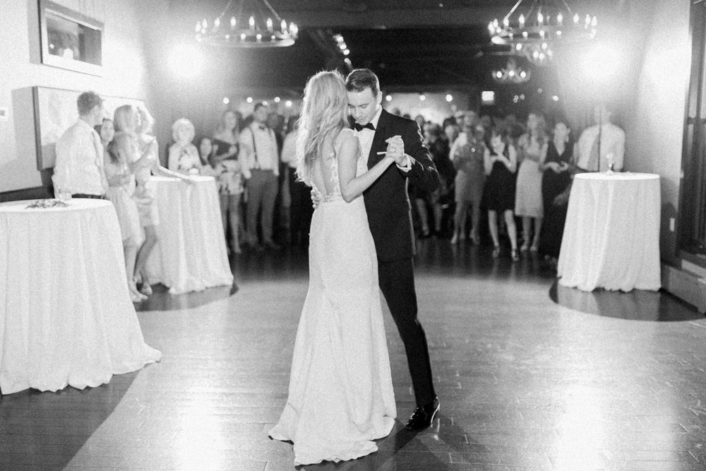 black and white photo of the bride and groom sharing their first dance at the lake house in Calgary