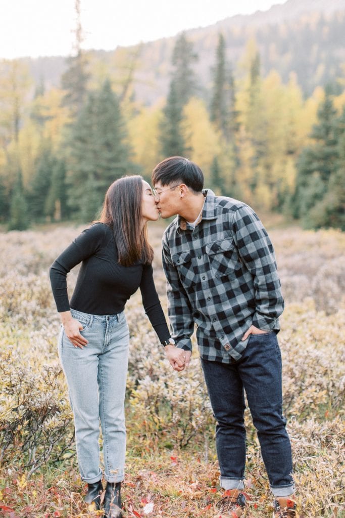Banff fall engagement session couple portrait kissing