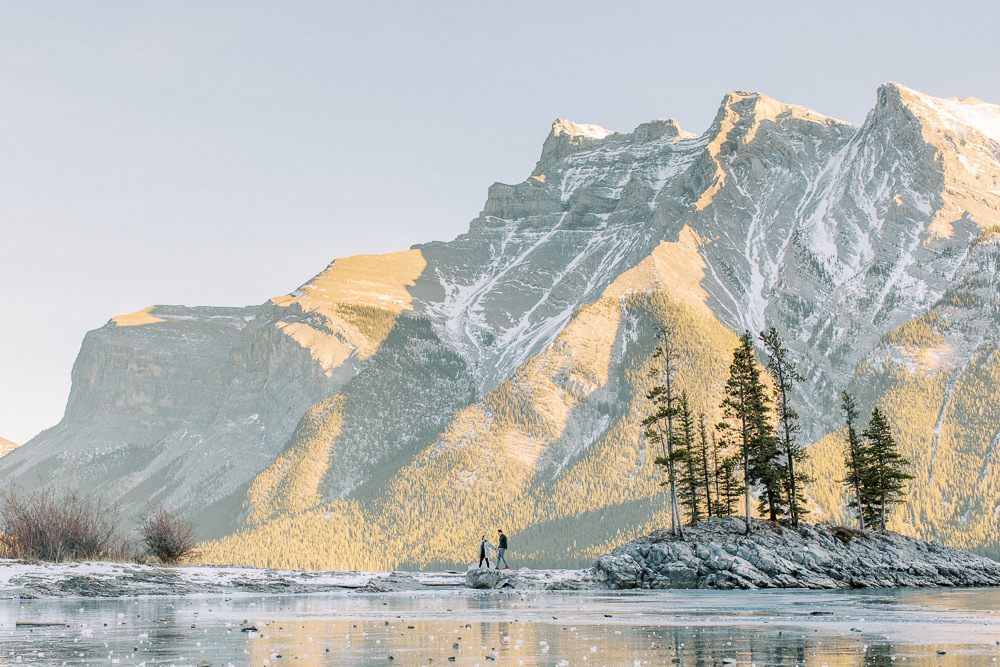 wide shot of the lake and mountain cape ofAlex and Hannah at Lake Minnewanka in Banff with their Calgary Wedding Photographer Heidrich photography