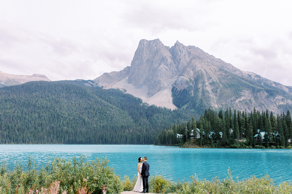 couple standing in front of Emerald lake lodge island one of the 8 best photography locations in Banff