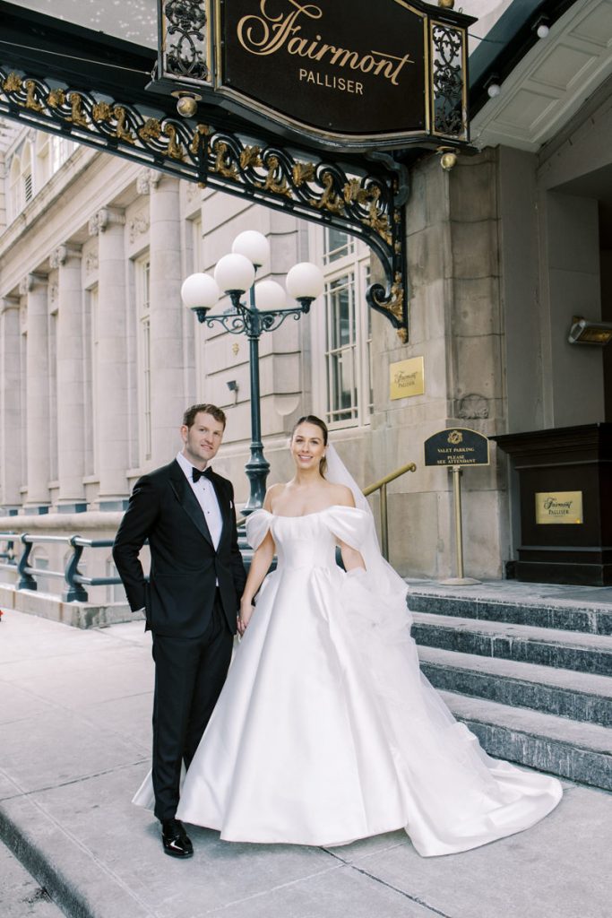 bride and groom in front of calgary fairmont palliser hotel