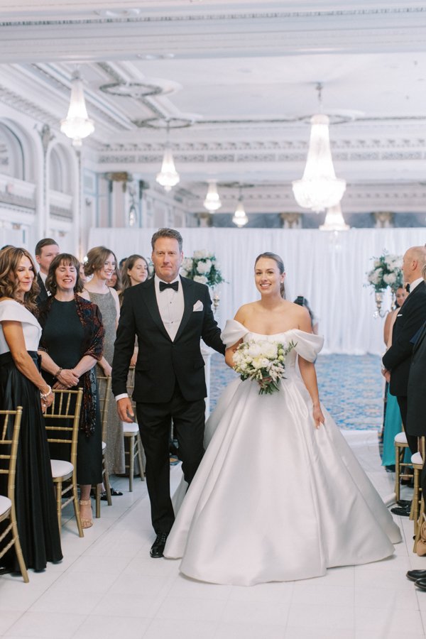 father walking bride down the isle at the Calgary Fairmont Palliser Hotel