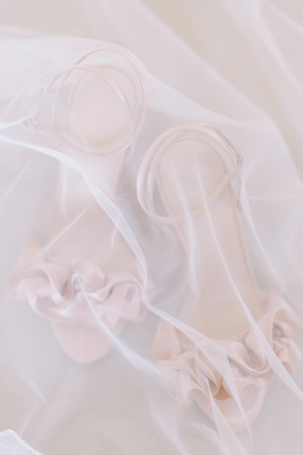 detail photo of wedding shoes with veil at the Calgary Fairmont Palliser Hotel