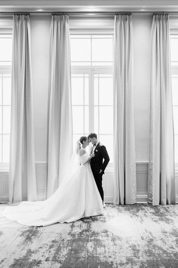 black and white shot of bride and groom sharing a moment at the Calgary Fairmont Palliser Hotel