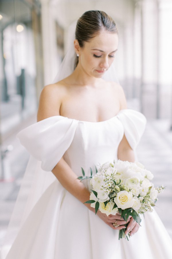 portrait of the bride with flowers standing at the Calgary Fairmont Palliser Hotel