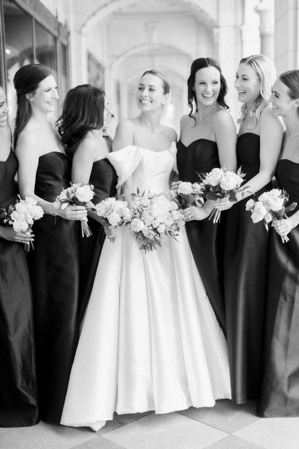 portrait of the bride with brides maids laughing at the Calgary Fairmont Palliser Hotel