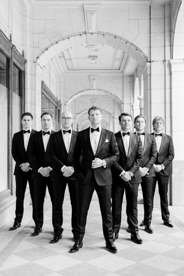 black and white portrait of the groom with grooms men at the Calgary Fairmont Palliser Hotel