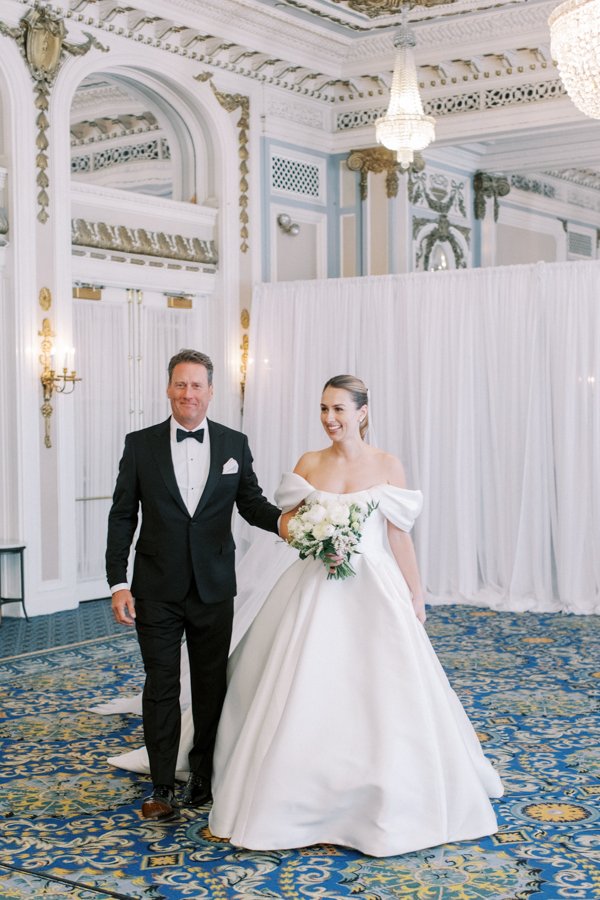 father walking bride down the isle at the Calgary Fairmont Palliser Hotel