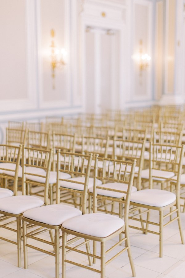 wedding ceremony set up with gold chairs the Crystal Ballroom at the Calgary Fairmont Palliser Hotel
