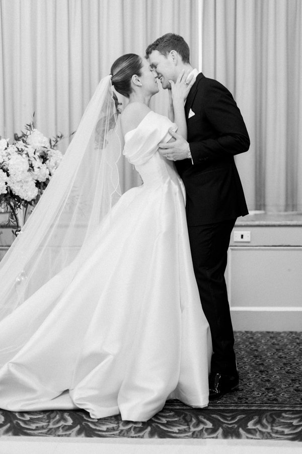 bride and grooms first kiss at the wedding ceremony the Crystal Ballroom at the Calgary Fairmont Palliser Hotel