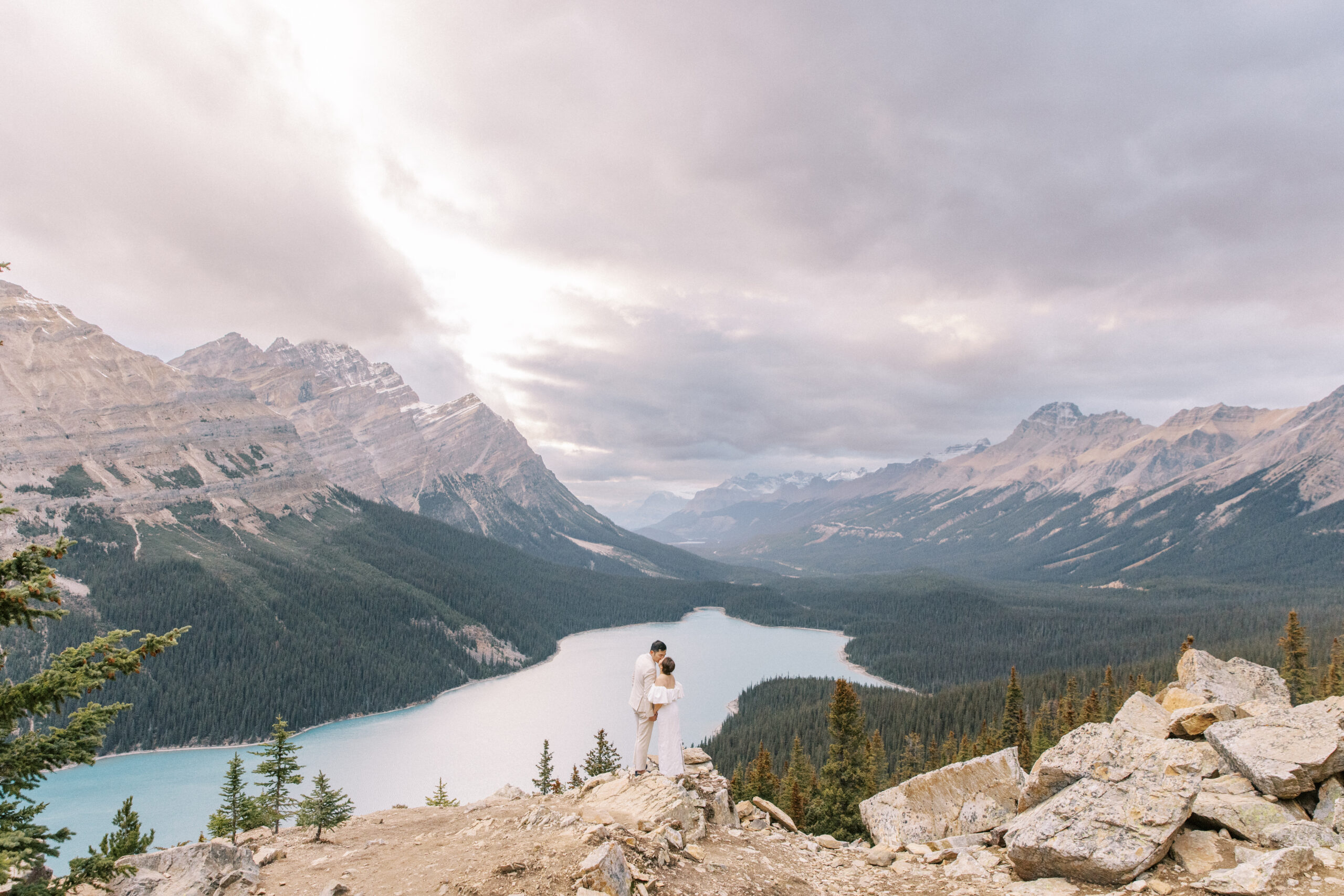 a couple standing at Peyto lake, one of the 8 best photography locations in Banff