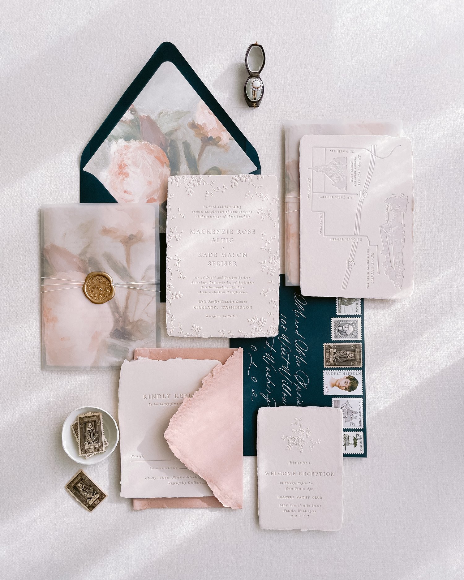 a wedding invite flat lay with stamps by Plume Calligraphy wedding stationery in Calgary