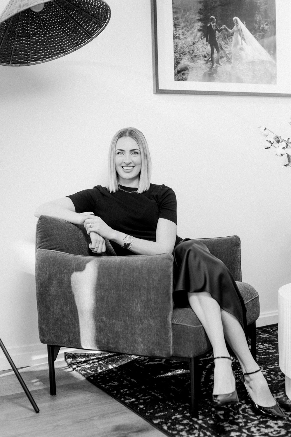 black and white portrait of Calgary wedding planner Julienne young in her Calgary office